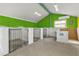 Interior view of a dog kennel with multiple cages and a washing station at 3000 Narcissus Ter, North Port, FL 34286