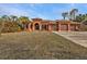 Attractive single-story home with three-car garage and lush landscaping at 3000 Narcissus Ter, North Port, FL 34286