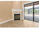 Cozy corner fireplace with stone surround and glass doors at 3000 Narcissus Ter, North Port, FL 34286