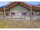 Green house with a covered porch and wooden railings at 3000 Narcissus Ter, North Port, FL 34286