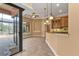 Kitchen with breakfast bar and access to the pool area at 3000 Narcissus Ter, North Port, FL 34286