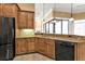 Kitchen features granite countertops, wood cabinets, and a breakfast bar at 3000 Narcissus Ter, North Port, FL 34286