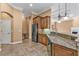 Kitchen boasts granite countertops and dark wood cabinets at 3000 Narcissus Ter, North Port, FL 34286