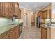 Kitchen with granite countertops, dark wood cabinets, and stainless steel appliances at 3000 Narcissus Ter, North Port, FL 34286