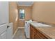 Bright laundry room with washer, dryer, and cabinets at 3000 Narcissus Ter, North Port, FL 34286