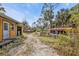 Gravel pathway leads to a small building and fenced area at 3000 Narcissus Ter, North Port, FL 34286