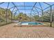 Enclosed pool and spa area with brick pavers at 3000 Narcissus Ter, North Port, FL 34286