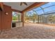 Spacious screened patio with brick pavers, pool view, and outdoor kitchen at 3000 Narcissus Ter, North Port, FL 34286