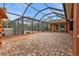 Screened patio with brick pavers and a view of the pool and spa at 3000 Narcissus Ter, North Port, FL 34286