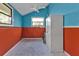 Simple room with a cabinet and a ceiling fan, painted in orange and teal at 3000 Narcissus Ter, North Port, FL 34286