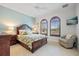 Bedroom with two arched windows and neutral decor at 3513 Terin Ct, Punta Gorda, FL 33950