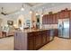 Island kitchen with granite countertops and rich wood cabinetry at 3513 Terin Ct, Punta Gorda, FL 33950
