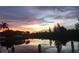 Stunning sunset over calm water with lush landscape and dock at 3513 Terin Ct, Punta Gorda, FL 33950