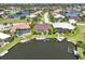 Drone view of canal-front home with private boat dock and pool at 3663 Whippoorwill Blvd, Punta Gorda, FL 33950