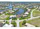 Aerial view of waterfront community, highlighting house and canal views at 3663 Whippoorwill Blvd, Punta Gorda, FL 33950