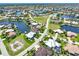 Wide aerial showcasing waterfront home and neighborhood at 3663 Whippoorwill Blvd, Punta Gorda, FL 33950