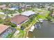 Aerial view of waterfront home with private dock and pool at 3663 Whippoorwill Blvd, Punta Gorda, FL 33950