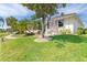 Landscaped backyard with lush lawn and mature trees at 3663 Whippoorwill Blvd, Punta Gorda, FL 33950