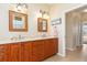 Double vanity bathroom with wood cabinets and marble counters at 3663 Whippoorwill Blvd, Punta Gorda, FL 33950