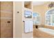 Spa-like bathroom with walk-in shower and soaking tub at 3663 Whippoorwill Blvd, Punta Gorda, FL 33950