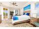 Main bedroom with large windows, balcony access, and water views at 3663 Whippoorwill Blvd, Punta Gorda, FL 33950