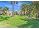 Single Gathering home with lush landscaping and palm trees at 3663 Whippoorwill Blvd, Punta Gorda, FL 33950