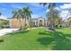 Well maintained house with palm trees and a spacious lawn at 3663 Whippoorwill Blvd, Punta Gorda, FL 33950
