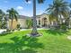 Single Gathering home with lush landscaping and palm trees at 3663 Whippoorwill Blvd, Punta Gorda, FL 33950