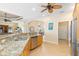 Open kitchen with granite countertops, stainless steel appliances, and breakfast bar at 3663 Whippoorwill Blvd, Punta Gorda, FL 33950