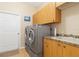 Laundry room with washer, dryer, and cabinets at 3663 Whippoorwill Blvd, Punta Gorda, FL 33950