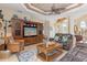 Bright living room featuring a large entertainment center and comfortable seating at 3663 Whippoorwill Blvd, Punta Gorda, FL 33950