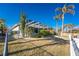 Landscaped backyard with a screened enclosure and canal view at 3932 Madrid Ct, Punta Gorda, FL 33950