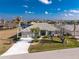 Single-story house with a tiled roof, palm trees, and a large driveway at 3932 Madrid Ct, Punta Gorda, FL 33950