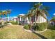 Tan one-story house with palm trees and manicured lawn at 3932 Madrid Ct, Punta Gorda, FL 33950