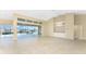 Bright living room with tile floors, high ceilings, and sliding doors to the pool at 3932 Madrid Ct, Punta Gorda, FL 33950