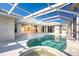 Inviting kidney-shaped pool and spa with a screened enclosure at 3932 Madrid Ct, Punta Gorda, FL 33950
