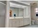 Double vanity bathroom with a large mirror and shower at 4046 Lubec Ave, North Port, FL 34287