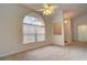 Bedroom with arched window, ceiling fan and neutral carpet at 4046 Lubec Ave, North Port, FL 34287