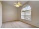 Bright bedroom with arched window, ceiling fan, and neutral carpet at 4046 Lubec Ave, North Port, FL 34287