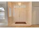 Bright entryway with double doors, chandelier, and tile flooring at 4046 Lubec Ave, North Port, FL 34287