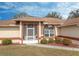 House entrance with screened porch and well-manicured landscaping at 4046 Lubec Ave, North Port, FL 34287