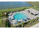 Community pool and surrounding area with lake views at 42115 Edgewater Dr, Punta Gorda, FL 33982