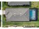 Aerial view of a home's rear, featuring a screened pool and well-maintained lawn at 42115 Edgewater Dr, Punta Gorda, FL 33982