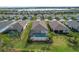 Aerial view of multiple homes, highlighting the community's layout and proximity to water at 42115 Edgewater Dr, Punta Gorda, FL 33982