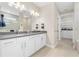 Bathroom with double vanity, large mirror, and walk-in shower at 42115 Edgewater Dr, Punta Gorda, FL 33982