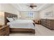 Bright bedroom with king bed, dresser, and ceiling fan at 42115 Edgewater Dr, Punta Gorda, FL 33982