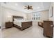 Spacious bedroom with a king-size bed, ceiling fan, and large windows at 42115 Edgewater Dr, Punta Gorda, FL 33982