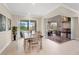 Open dining area with sliding doors leading to an outdoor kitchen and pool at 42115 Edgewater Dr, Punta Gorda, FL 33982