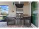 Stainless steel outdoor kitchen with grill and refrigerator at 42115 Edgewater Dr, Punta Gorda, FL 33982