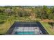 An elevated view of a refreshing pool with a screened enclosure, perfect for relaxation at 42115 Edgewater Dr, Punta Gorda, FL 33982